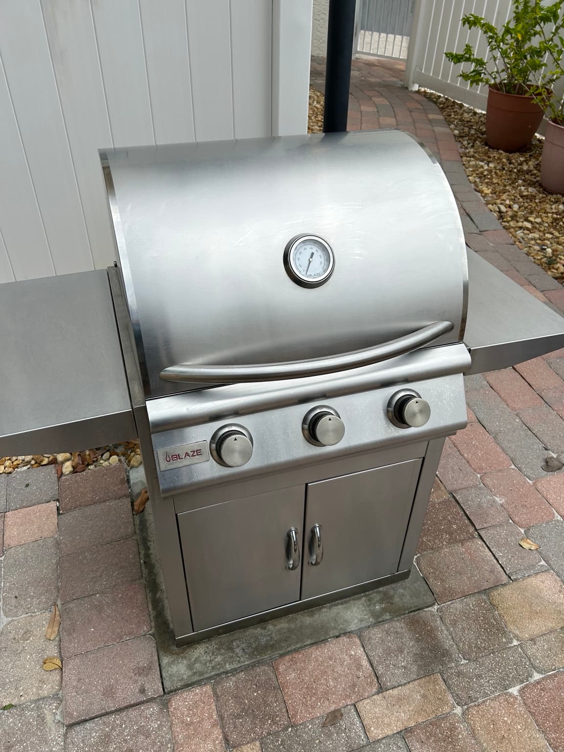 Clean stainless steel Blaze freestanding grill on a Tampa Bay patio