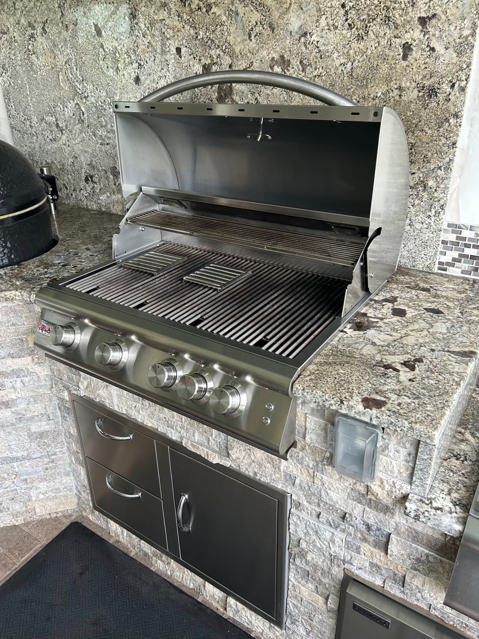 Professionally cleaned stainless steel Blaze built-in grill in a Tampa Bay outdoor kitchen ready for football season.