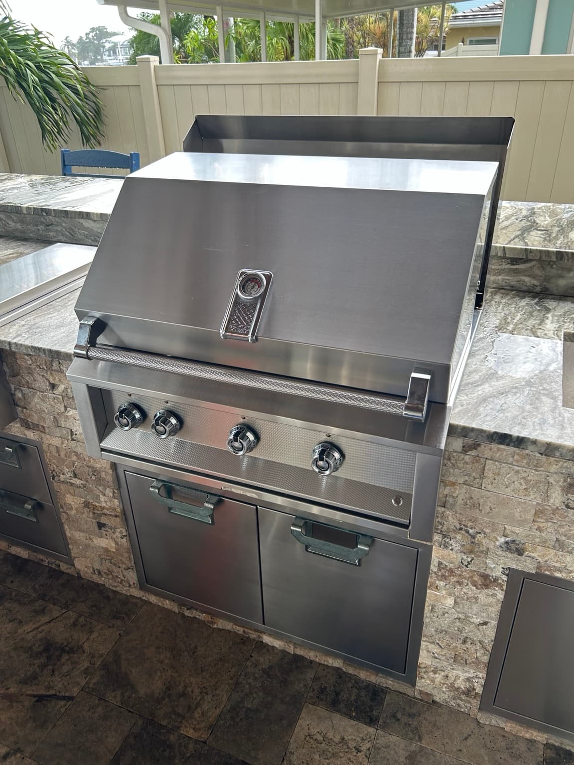 Professionally restored stainless steel built-in grill in a Tampa Bay outdoor kitchen